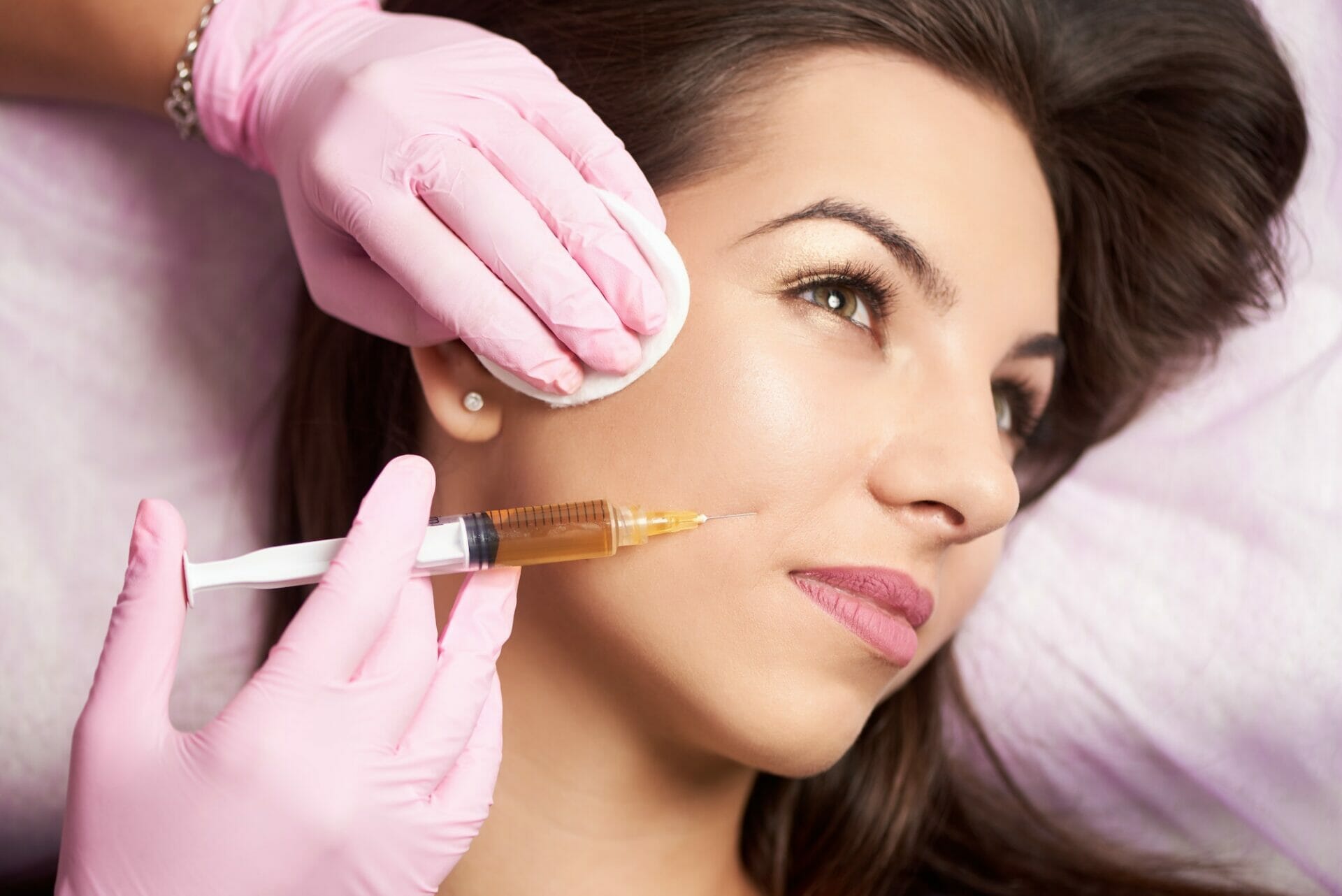 Close-up of beautiful woman getting injection in the cosmetology salon.