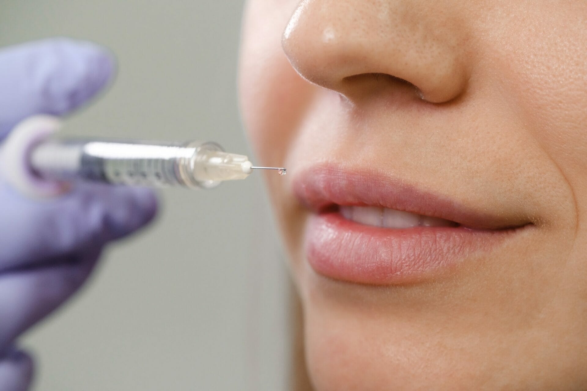 Lips augmentation injections. Cosmetology rejuvenating facial treatment